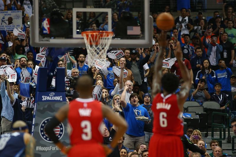 DeAndre Jordan shooting a free throw in 2015 as fans scream towards him.