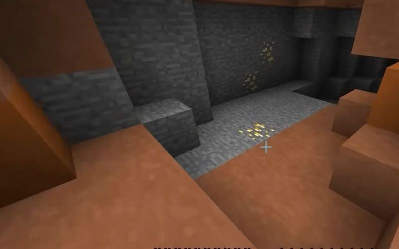 Gold ore generated on the surface of a mesa biome in Minecraft (Image via iDeactivateMC/YouTube)