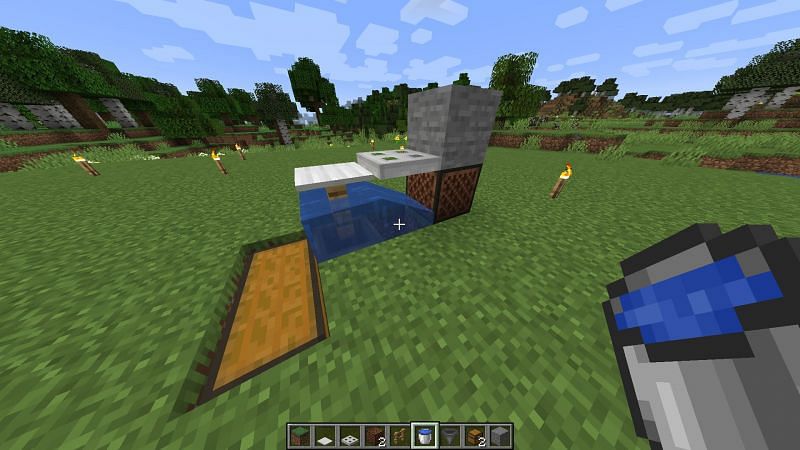 Players will have to place a water bucket onto the hopper (Image via Minecraft)