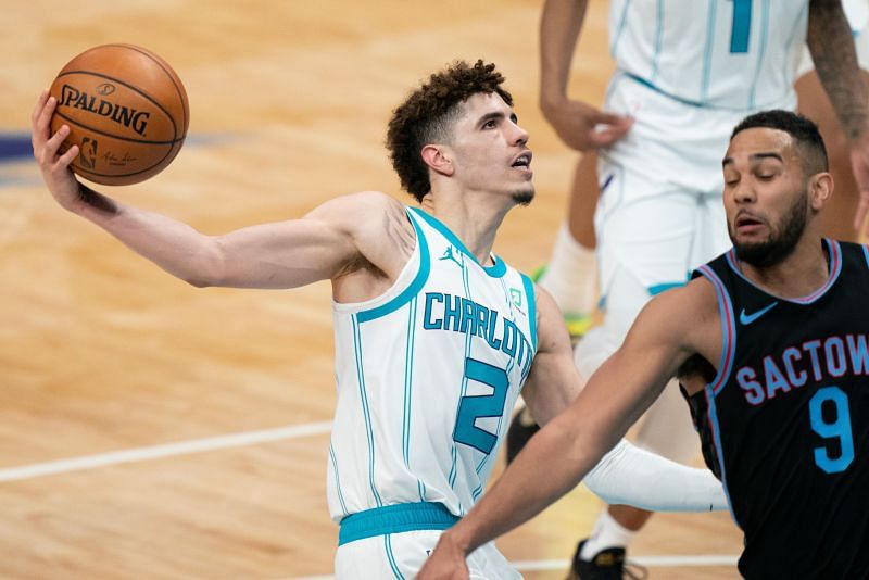 LaMelo Ball #2 drives to the basket against Cory Joseph #9