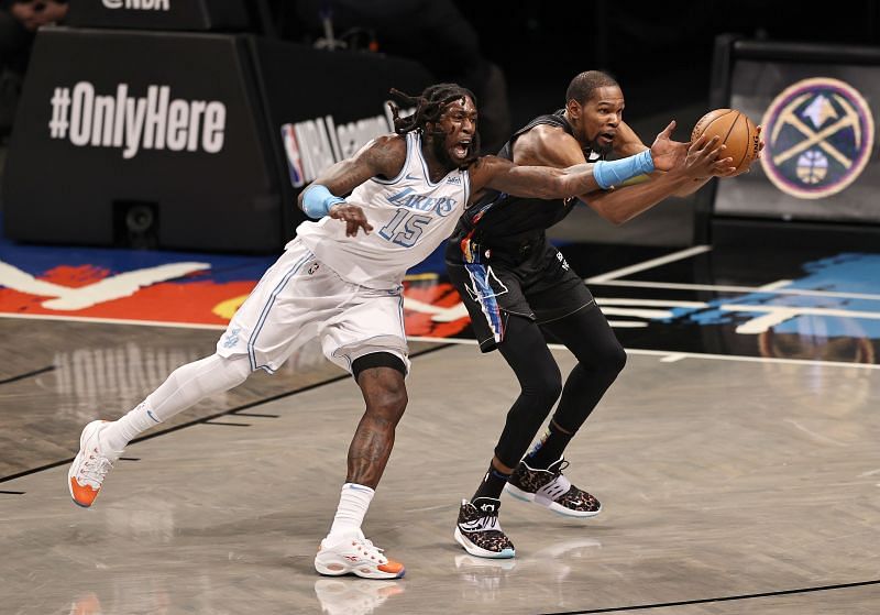 Montrezl Harrell #15 and Kevin Durant #7 fight for the ball.