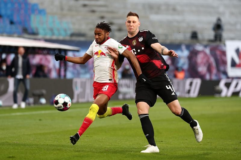 RB Leipzig&#039;s Christopher Nkunku battles for the ball with Niklas Sule of Bayern Munich.