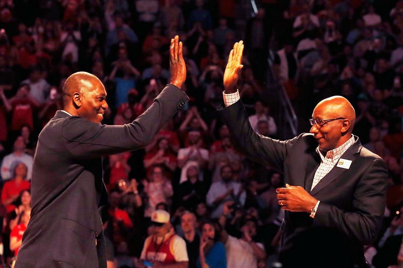 Hakeem Olajuwon (L) and Cylde Drexler greet each other on the court.