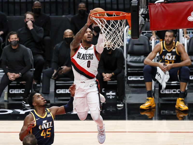 Donovan Mitchell #45 of the Utah Jazz watches as Damian Lillard #0 of the Portland Trail Blazers shoots