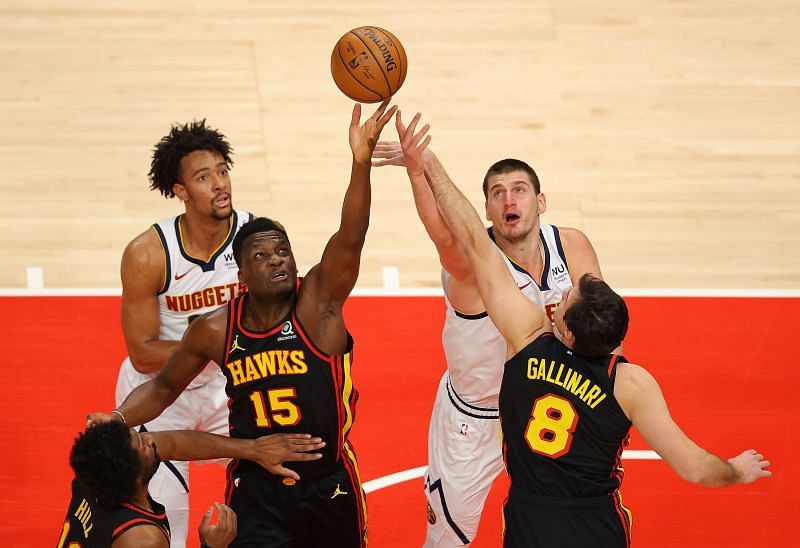 Clint Capela #15 and Danilo Gallinari #8 battle for a rebound against Zeke Nnaji #22 and Nikola Jokic #15 