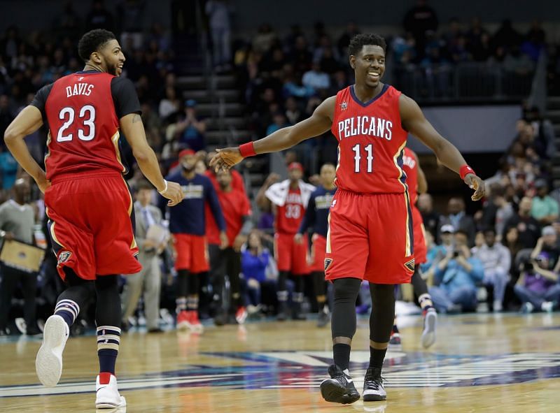 Jrue Holiday #11 and Anthony Davis #23 react after a play