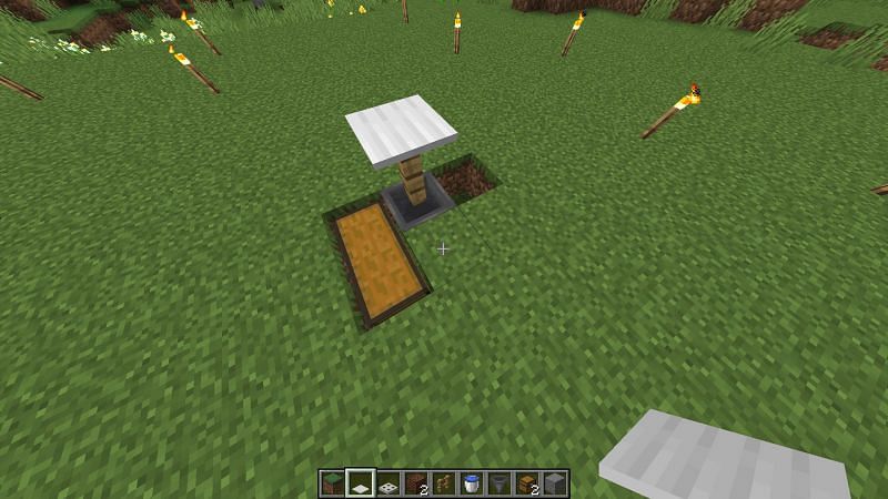 Players should place two chests at the bottom of the L-shaped hole (Image via Minecraft)