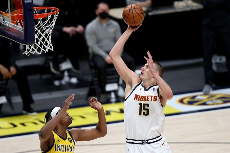 Nikola Jokic #15 puts up a shot over Myles Turner #33.