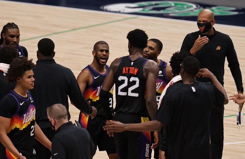 Chris Paul #3 of the Phoenix Suns talks with #22 Deandre Ayton during a team huddle.