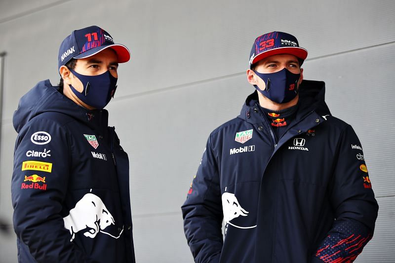 Max Verstappen and Sergio Perez of Red Bull Racing talk in the pit lane during filming day at Silverstone . Photo: Mark Thompson/Getty Images for Red Bull Racing.