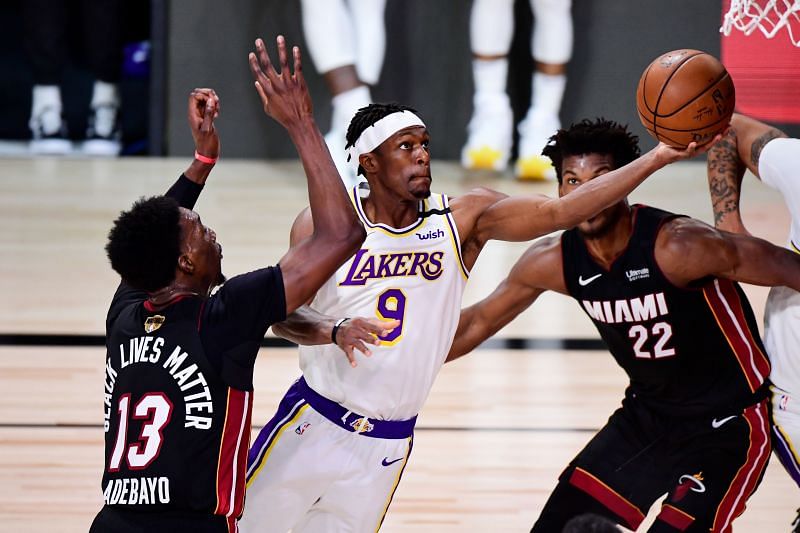 Rajon Rondo #9 drives to the basket against Jimmy Butler #22 and Bam Adebayo #13 of the Miami Heat