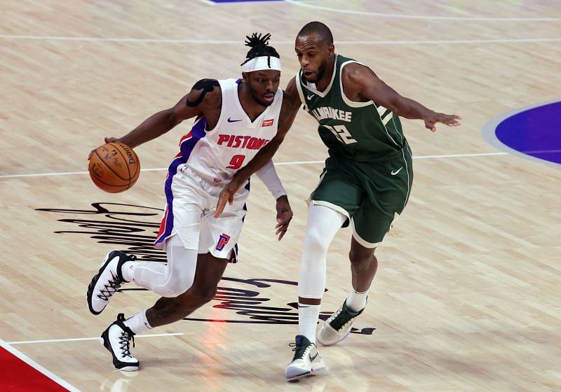 Jerami Grant (with ball) driving on Khris Middleton