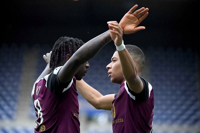 Kylian Mbappe celebrates with Moise Kean