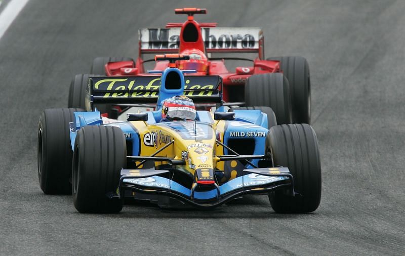 Alonso put up a stern defense against Schumacher to win the race. Photo: Clive Mason/Getty Images.