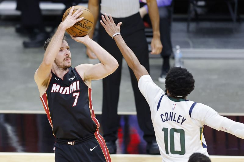 Goran Dragic #7 shoots over Mike Conley #10. Jimmy Butler #22 drives to the basket against Alec Burks #18