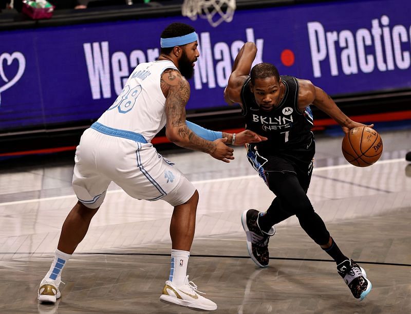 Kevin Durant #7 heads for the net as Markieff Morris #88 defends.