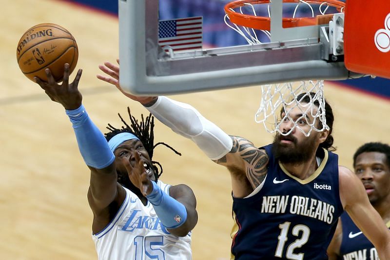 Montrezl Harrell #15 shoots over Steven Adams #12