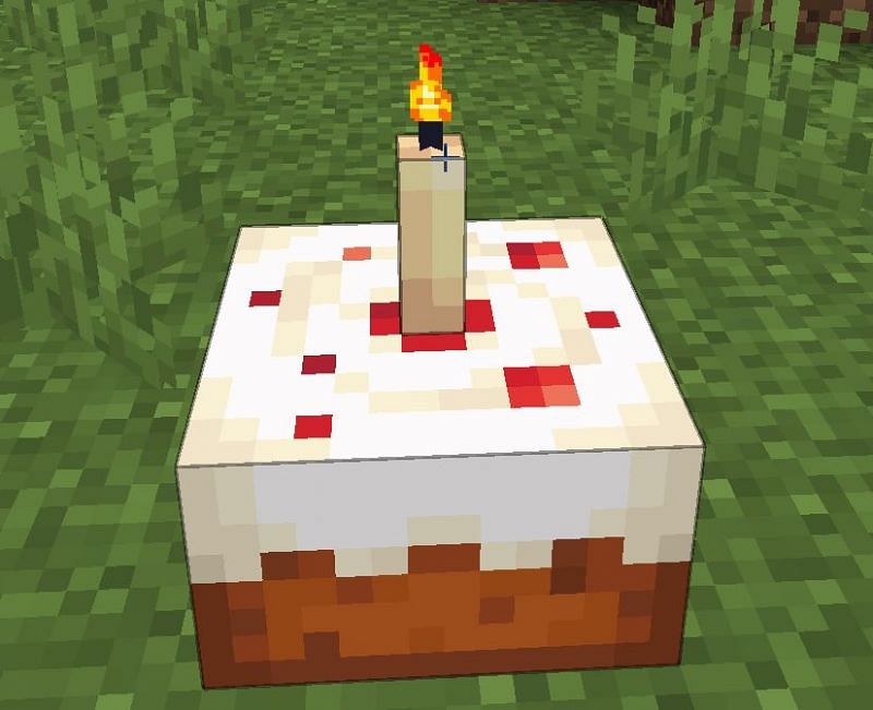A Minecraft cake with a candle stuck inside