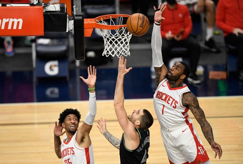 Juancho Hernangomez of the Minnesota Timberwolves shoots the ball against Christian Wood and John Wall of the Houston Rockets.