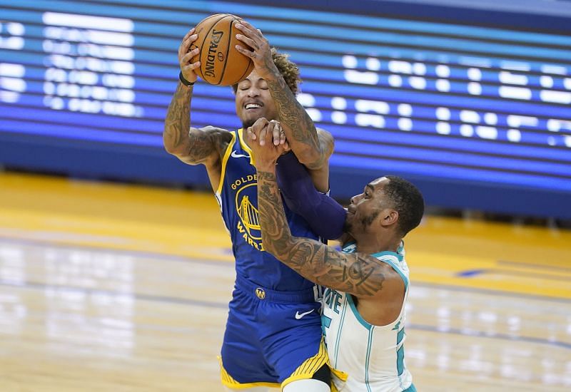 Kelly Oubre Jr. #12 goes after a pass down the court and gets fouled by P.J. Washington #25