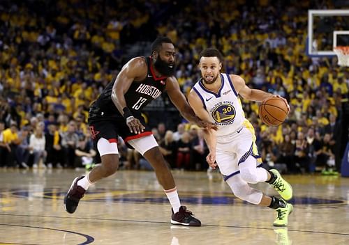 Steph Curry (#30) drives the ball past James Harden. 