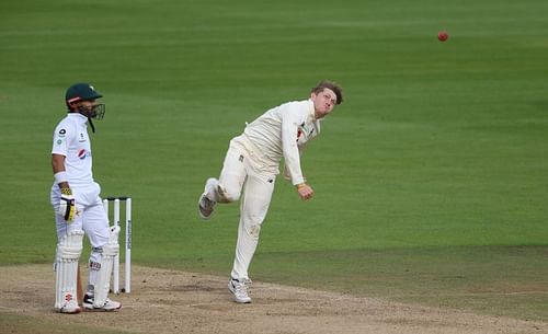 Dom Bess (R) in his bowling action.