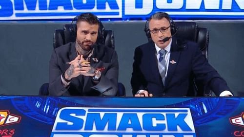 Corey Graves and Michael Cole at the SmackDown announce desk.