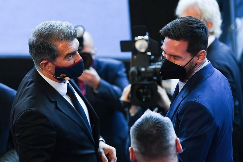 Barcelona president Joan Laporta (L) and Lionel Messi