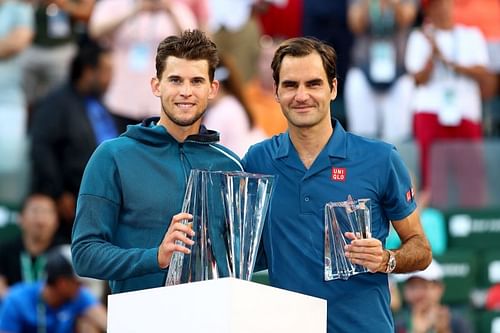 Dominic Thiem (L) and Roger Federer pose at the 2019 Indian Wells Masters trophy ceremony