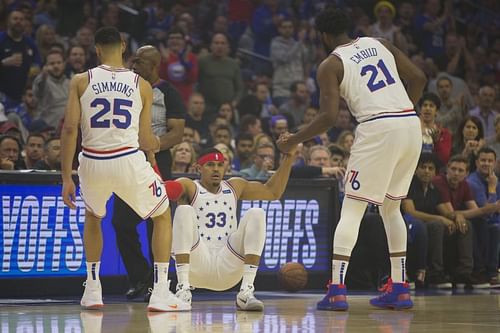 Ben Simmons #25 and Joel Embiid #21 help Tobias Harris #33 off the floor