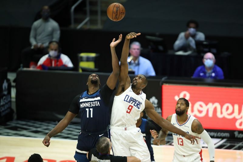 Naz Reid (#11) of the Minnesota Timberwolves tips off against Serge Ibaka (#9) of the LA Clippers.