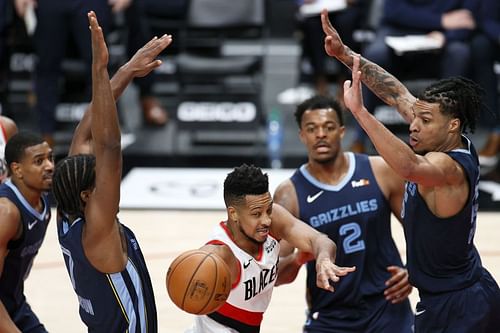 CJ McCollum tries to finish in traffic