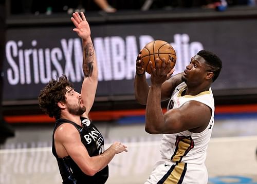 Zion Williamson #1 heads for the net as Joe Harris #12 defends