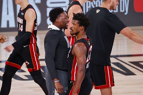 Jimmy Butler #22 of the Miami Heat reacts with Bam Adebayo #13 