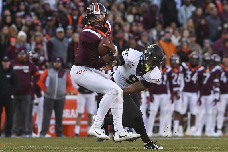 Wake Forest defensive end Carlos Basham Jr. reaches to tackle Virginia Tech quarterback Hendon Hooker on Nov. 9, 2019.