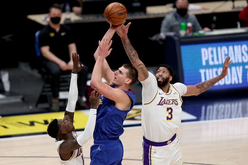 Nikola Jokic #15 goes to the basket against Dennis Schroder #17 and Anthony Davis #3.