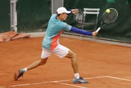 Alex de Minaur retrieves a ball