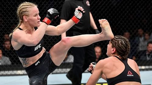 Valentina Shevchenko (left) head kicks Jessica Eye (right) at UFC 238.