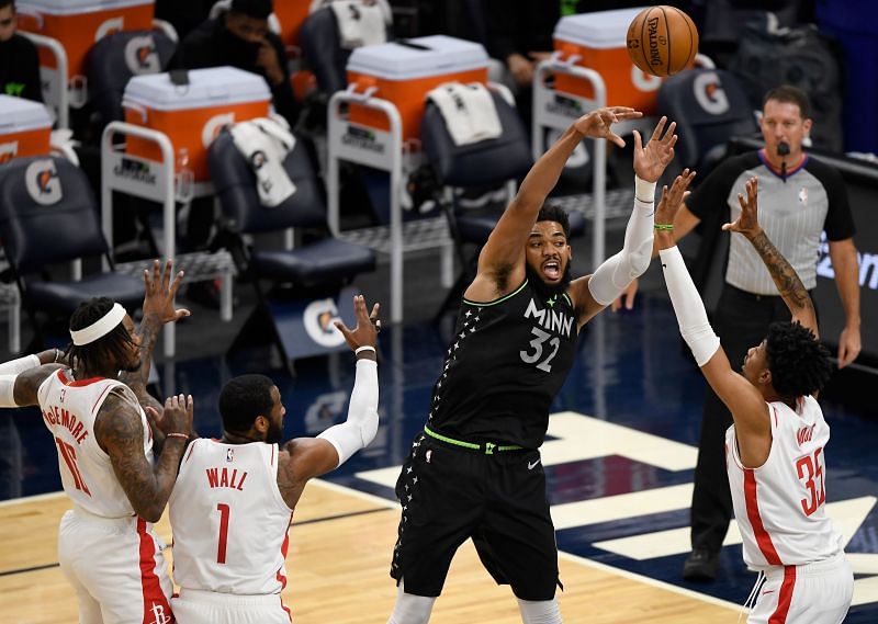 Karl-Anthony Towns #32 passes the ball away from Ben McLemore #16, John Wall #1 and Christian Wood #35