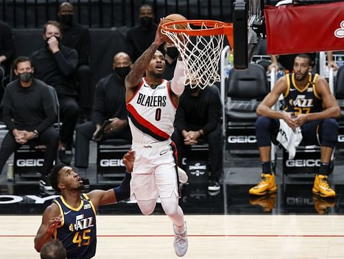 Donovan Mitchell #45 watches as Damian Lillard #0 shoots