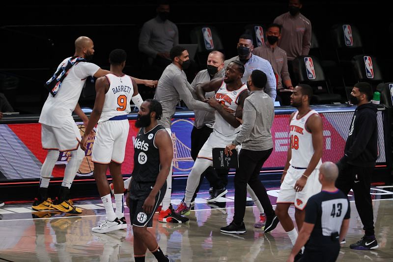 Julius Randle #30 is restrained by teammates after their 117-112 loss against the Brooklyn Nets