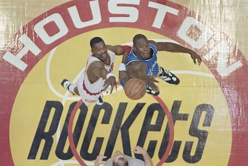 Hakeem Olajuwon contests the ball at the tip off against Shaquille O'Neal.