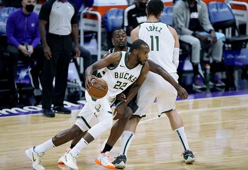 Khris Middleton #22 dribbles around a screen set by Brook Lopez #11 on Harrison Barnes #40.