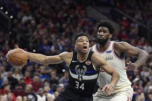 Giannis Antetokounmpo #34 of the Milwaukee Bucks looks to pass as Joel Embiid #21 of the Philadelphia 76ers defends.