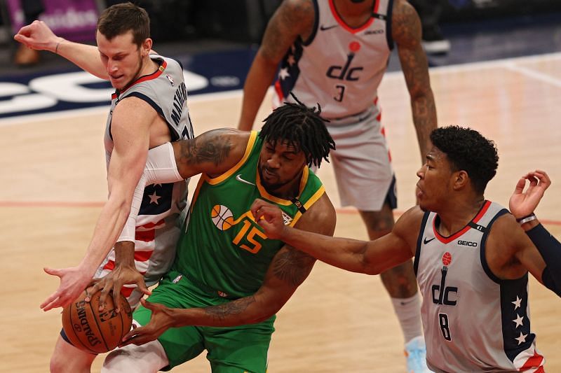 Derrick Favors #15 and Garrison Mathews #24 battle for a rebound.