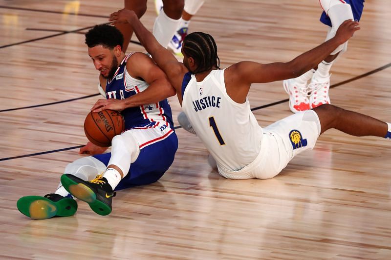 Ben Simmons fights for the loose ball