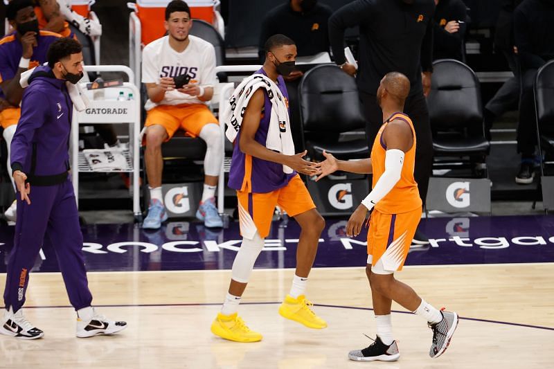 Mikal Bridges #25 and Chris Paul #3 high five.