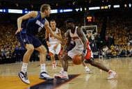 Stephen Jackson #3 of the Golden State Warriors drives to the basket against Dirk Nowitzki #41 of the Dallas Mavericks.