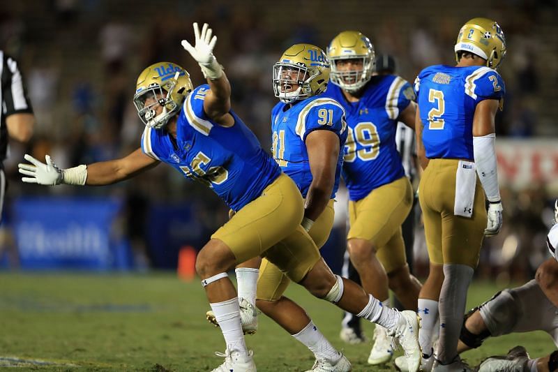 Former UCLA Bruin Jaelan Phillips and Jacob Tuioti-Mariner celebrate a sack against Texas A&amp;M quarterback Kellen Mond during the second half of the Rose Bowl on Sept. 3, 2017.