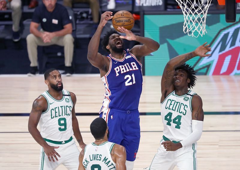 Joel Embiid #21 is fouled by Robert Williams #44